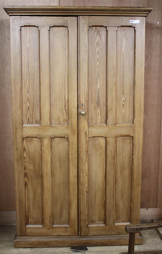 An Edwardian pitched pine hall cupboard, with two panelled doors enclosing two fixed shelves and fittings for adjustable shelves, W.116